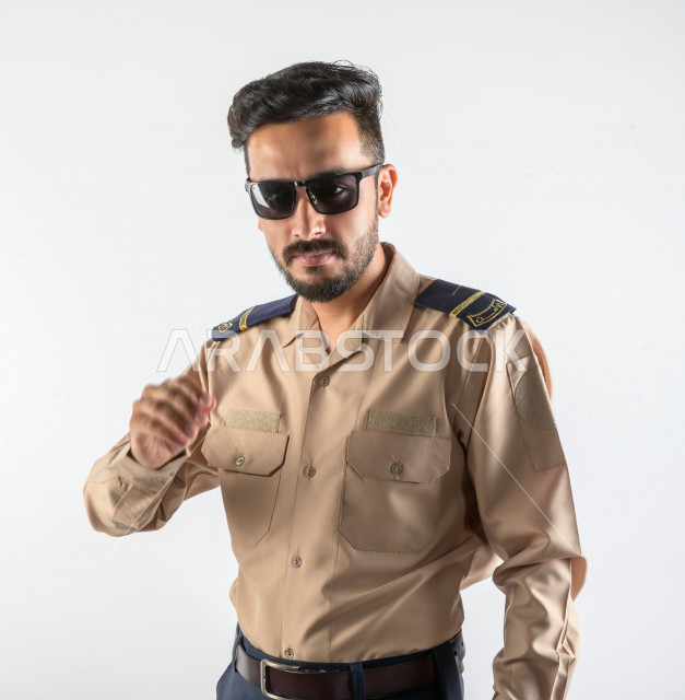 Portrait of a Saudi Arabian Gulf man working as a security man, wearing uniforms to work, maintaining security and reassurance, guard and safety, white background