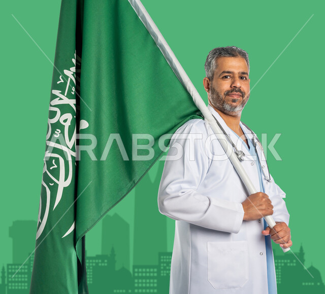 العمل في المجال الصحي, تقديم الخدمات الطبية, مهن ووظائف سعودية, بورتريه مقرب لطبيب عربي خليجي سعودي يرتدي المعطف الطبي الأبيض وسماعة الفحص يمسك علم المملكة بفخر واعتزاز, التعبير عن الانتماء للوطن في العيد الوطني 23 سبتمبر, يوم العلم 11 مارس, خلفية الأبراج