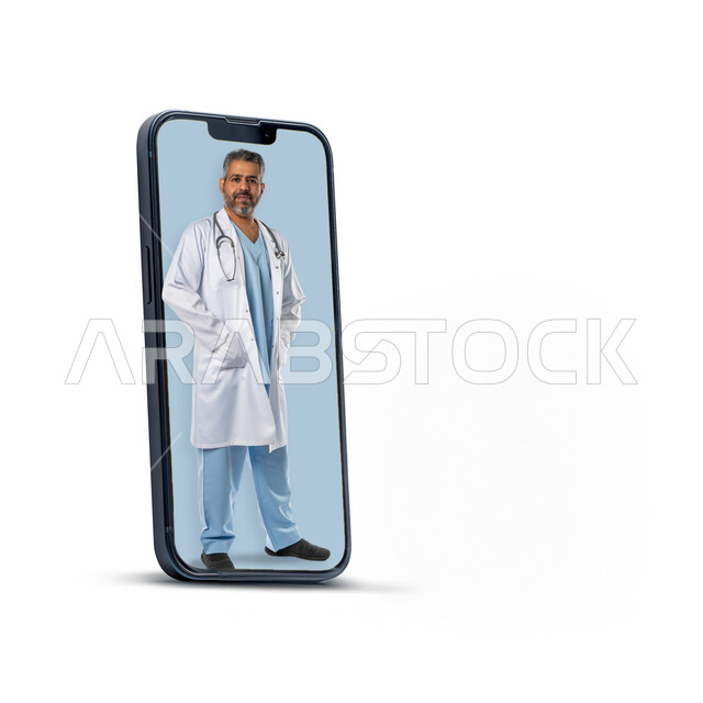 تقديم الخدمات الطبية عن بعد، بورتريه لطبيب عربي خليجي سعودي يرتدي المعطف الابيض والسماعات الطبية على خلفية زرقاء لهاتف محمول كبير، استشارات صحية عبر الجوال، مفهوم الطب والرعاية الصحية، خلفية بيضاء