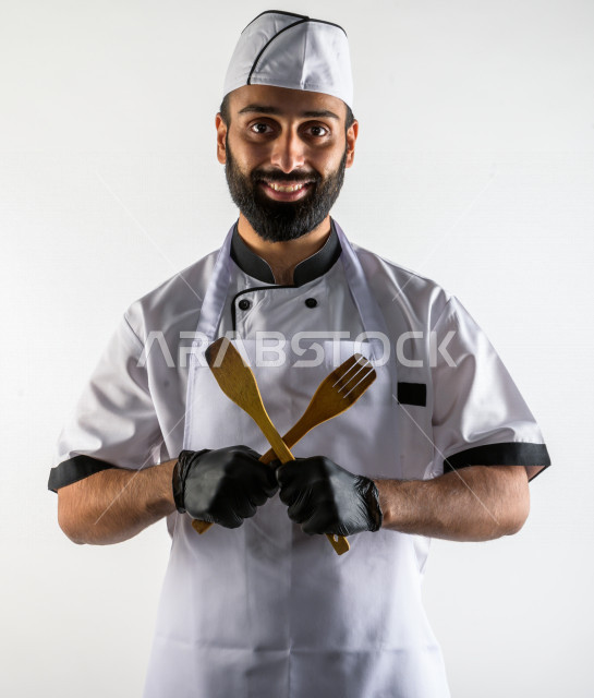 بورتريه لشيف طباخ سعودي خليجي خبير و ناجح  في العمل، يعمل في مجال الطبخ و الفندقة ، يرتدي الزي الرسمي الخاص بمزاولة مهنة الطباخ ، خلفية بيضاء