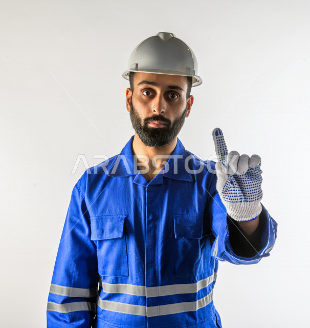 Portrait of a successful Saudi Gulf firefighter, emergency firefighting equipment, works in the rescue field, wears a uniform for practicing the profession of civil defense, white background