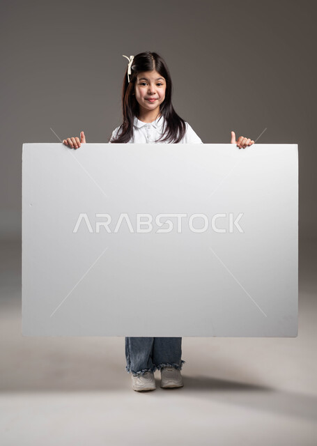 White square mockup, empty billboard, looking at the camera with happy gestures, using expressive illustrative paintings, portrait of a smiling Saudi Arabian Gulf girl wearing a casual outfit and holding a white square billboard in her hands, full-length body portrait, gray background