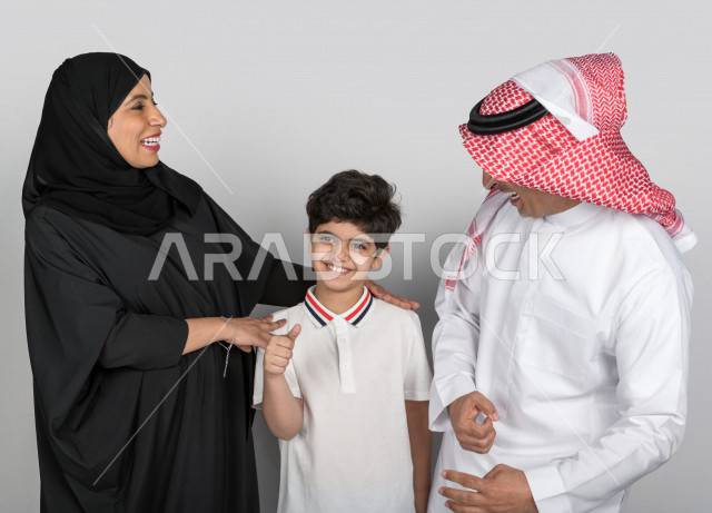 Happy Saudi Arabian Gulf family, with different hand gestures and faces, facial expressions, family time, Saudi family