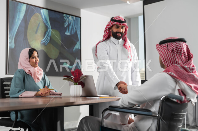 Shaking hands, welcoming and receiving, conducting recruitment and employment interviews, providing job opportunities for people of determination and integrating them into society, using modern technological devices, cooperation and unity among team members, the concept of equality between women and men, a group of employees in the meeting room inside the company’s headquarters.
