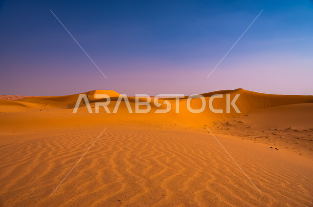 Badia regions and desert climate in Riyadh, close-up view of sunset on desert sand dunes in the Kingdom of Saudi Arabia, sand hills in the desert, soft golden sand, nature background