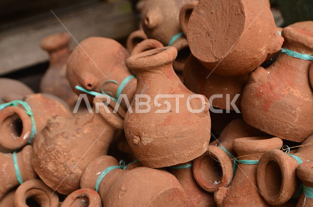 Ancient Islamic heritage, popular pottery, traditional crafts and handicrafts, close-up of pottery jars and jugs made of clay, local national products made in the Kingdom of Saudi Arabia