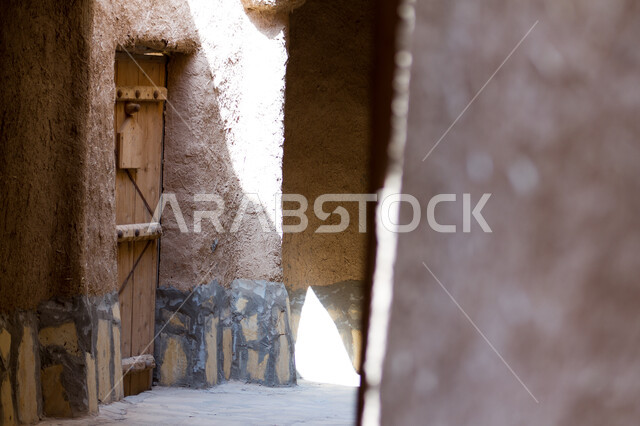 Historical houses in the city of Riyadh, ancient Arab architectural design of ancient antique wooden doors, architectural engineering art of ancient mud buildings in the village of Ushaiqar in Al-Shaqra Governorate, famous heritage tourist places in Saudi Arabia