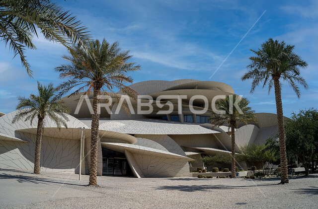 Modern architectural art, natural formations of the Qatar National Museum building on the Doha Corniche, famous tourist attractions, ancient museums and palaces, urban growth and progress, tourist attractions.
