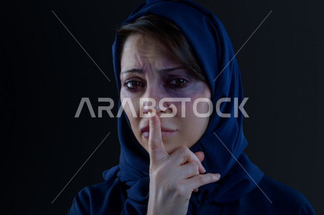 Expressions and emoticons of the face and hands of a Saudi woman subjected to physical violence, stop violence against women, end violence against women, November 25, International Day for the Elimination of Violence Against Women, physical bruising