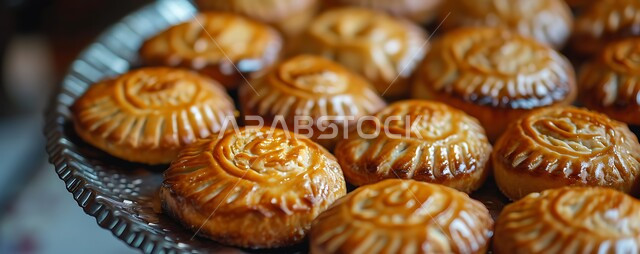 Fresh traditional sweets, a close-up of a plate of maamoul tablets stuffed with dates, fragile popular biscuits, delicious Eid cakes, and distinctive dessert recipes and dishes