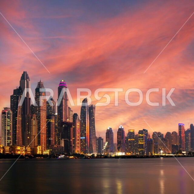 أفق دبي وقت غروب الشمس، التطور العمراني الهندسي الفني للأبراج وناطحات السحاب في الإمارات العربية المتحدة, الفن المعماري على الطراز الحديث والمتطور للمباني على الواجهة البحرية, معالم وأماكن السياحة المشهورة, منظر السماء المليئة بالغيوم والسحب 