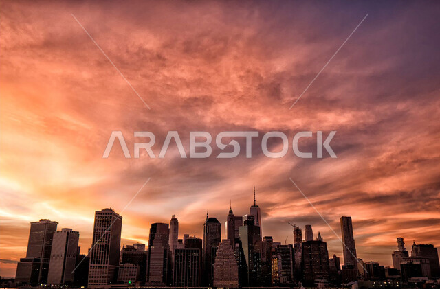 Tourist entertainment places and attractions, urban progress of facilities on the Doha Corniche, Al-Dafna Towers and skyscrapers in the city of Qatar, architectural engineering designs in a modern and advanced style, engineering art of facilities and buildings at sunset.