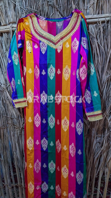 Women's fashion with antique engravings and drawings, different textiles and colors, popular costume in the Emirates city, ancient Arab customs and traditions, heritage, originality and nobility, traditional Arab clothing from the Emirati heritage