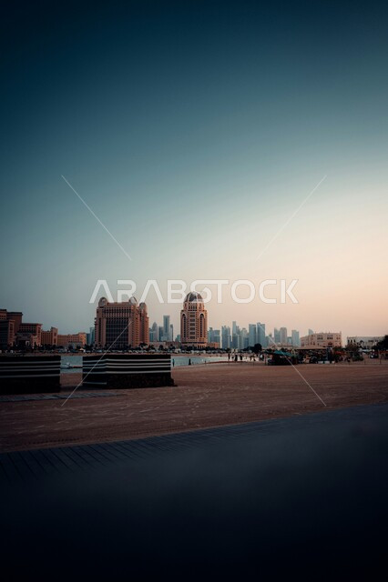 Famous tourist and entertainment landmarks, the architectural art of towers and skyscrapers in the city of Qatar, buildings and facilities overlooking the sea, tourist places and areas in Doha, enjoying the calm sea atmosphere on Katara Beach.