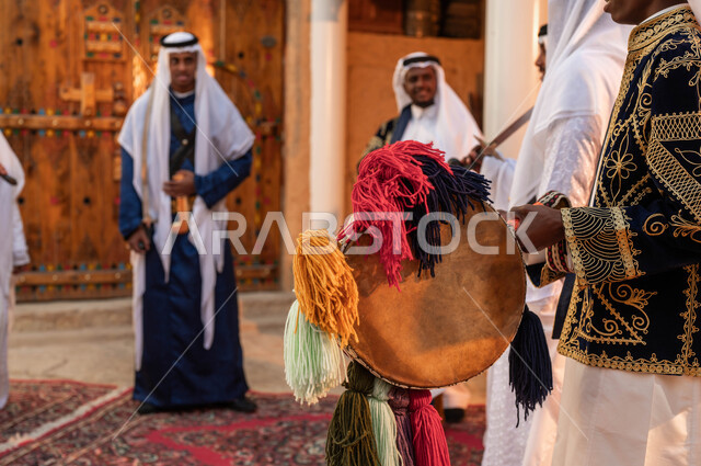 A group of Saudi Gulf Arab men celebrate the anniversary of the founding of the Saudi state, February 22, wearing popular Najdi parade costumes, folk dancing, songs, and drumming on national occasions, celebrating Badina Day 1727, love for the homeland and belonging to it.