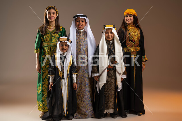 Anniversary of the founding of the Saudi state, February 22, pride and flaunting of the country’s achievements, teaching children to be proud and proud of national identity, Day of Our Day 1727 AD, portrait of a group of Saudi Gulf Arab boys wearing traditional popular traditional dress, full-length body portrait, beige background