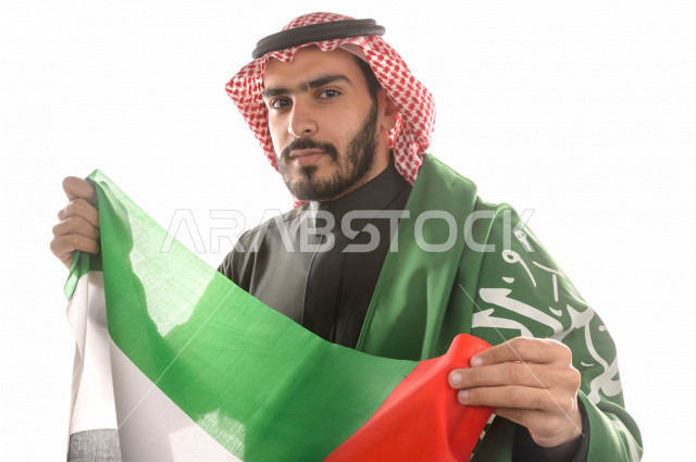 Portrait of a man carrying the flags of both Saudi Arabia and the United Arab Emirates.
