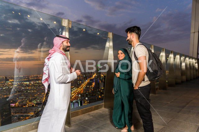 A group of people on a wonderful visit at the top of Al Faisaliah Tower, the skyscrapers of Riyadh in the Kingdom of Saudi Arabia, Kingdom Tower, Kingdom Tower skyline on the National Day, Riyadh Season, Saudi National Day, Riyadh Towers