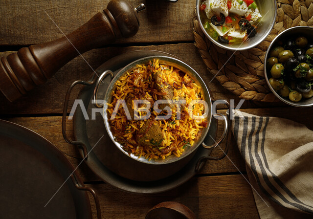 Biryani rice with grilled meat, dishes from popular traditional Arabic cuisine, Bukhari rice with meat, Saudi cuisine meals, delicious healthy delicious food recipes, a picture from the top of a dish of kabsa rice with meat