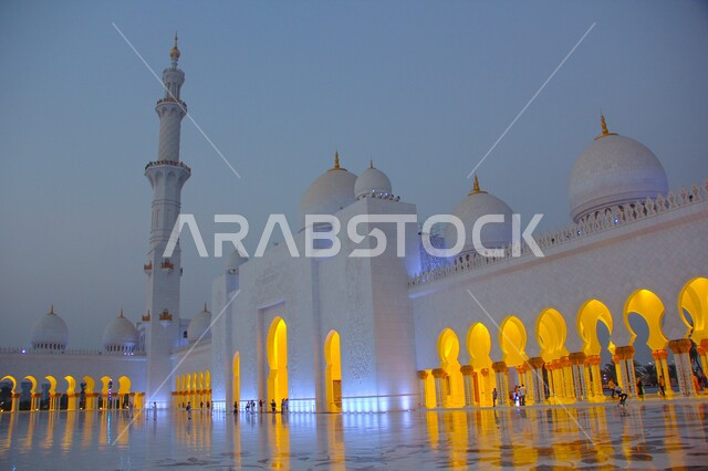 The modern Islamic style of the mosques of the United Arab Emirates, places of worship and closeness to God Almighty, famous Islamic landmarks, architectural engineering art in building the white domes on the Sheikh Zayed Grand Mosque in the Emirate of Abu Dhabi during the day