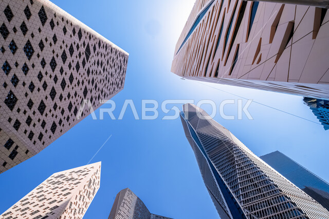 The development of the architectural engineering art of the famous buildings and skyscrapers in the Kingdom of Saudi Arabia, the achievement of the economic and commercial renaissance, a close-up picture from the bottom of the financial towers in the city of Riyadh, the King Abdullah Financial Center (KAFD) in the daytime