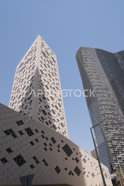Modern style architectural art of the famous buildings and skyscrapers in the Kingdom of Saudi Arabia, achieving economic and commercial renaissance, a close-up photo from the bottom of the financial towers in the city of Riyadh, the King Abdullah Financial Center (KAFD) at daytime