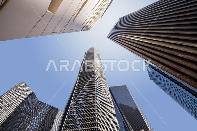 The development of the architectural engineering art of the famous buildings and skyscrapers in the Kingdom of Saudi Arabia, the achievement of the economic and commercial renaissance, a close-up picture from the bottom of the financial towers in the city of Riyadh, the King Abdullah Financial Center (KAFD) in the daytime