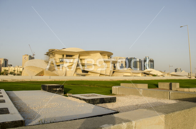 Famous landmarks, museums and palaces, modern architectural art, geometric formations of the Qatar National Museum building on the Doha Corniche, urban growth and progress, areas that attract tourists to learn about Qatari heritage and civilization.