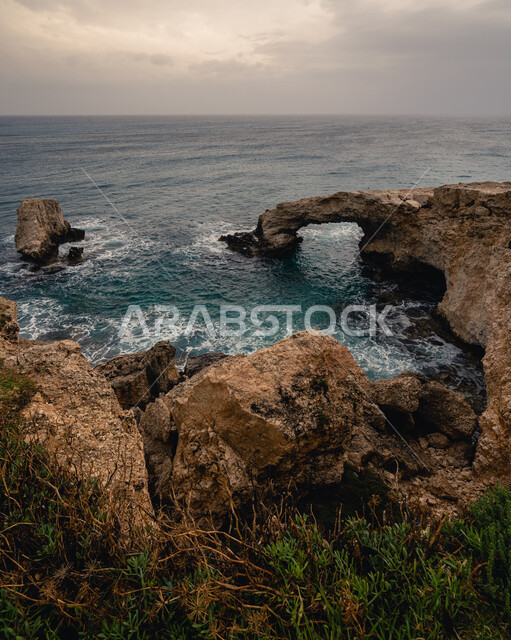 A picture from above of the rock formations and formations around the sea water at sunset, the mountain peaks and heights in the Kingdom of Saudi Arabia, enjoying the natural scenery in tourist places.