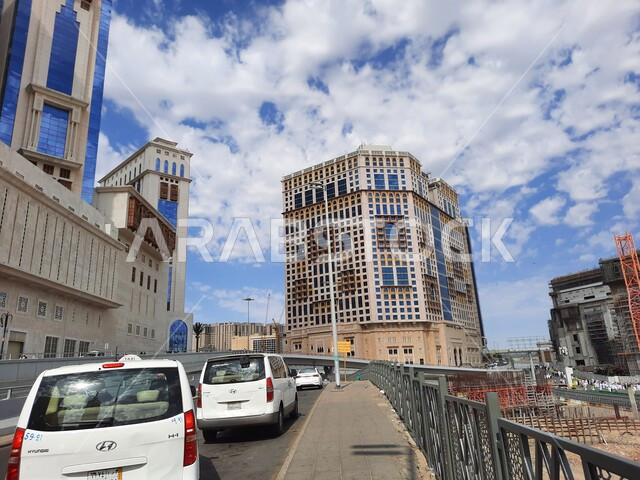 Interest in construction and urban development in Mecca, car movement on roads and paved streets during the day in the Kingdom, luxury hotels and towers, lifestyle in Saudi Arabia.