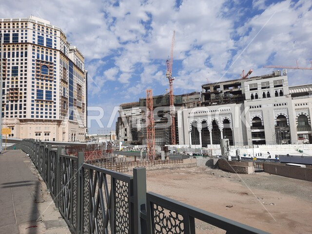 A destination for Muslims from all over the world to perform worship and get closer to God, sacred Islamic religious places and landmarks in the Kingdom of Saudi Arabia, the outer entrance to the courtyard of the Grand Mosque of God in Mecca, the scene of clouds in the blue sky