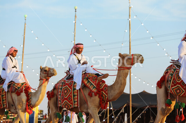 National Day on September 23, generational transmission of the ancestral heritage of love for purebred camels, a group of Saudi Gulf Arab men riding camels in the desert, practicing traditional popular activities, the anniversary of the founding of the first Saudi state on February 22, Badina Day 1727 AD.