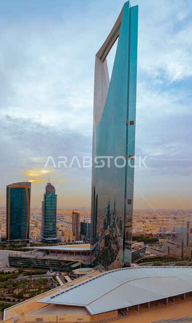 The advanced architectural engineering art in the Kingdom of Saudi Arabia, a close-up picture from the side of the Kingdom Tower in the city of Riyadh, the growth and urban progress of towers and skyscrapers, famous tourist areas and landmarks