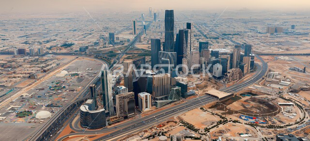 Progress, development and urban growth in Saudi Arabia, the King Abdullah Financial Center (CAFD) in the city of Riyadh, modern architectural art for towers and skyscrapers in the Kingdom, traffic in the streets and roads