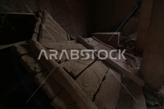A broken wooden door lying on the ground inside a popular heritage mud building in the village of Ushaiqar in the city of Riyadh, famous places and tourist attractions in the Kingdom of Saudi Arabia, attracting tourists from all over the world.