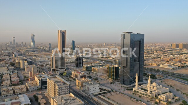 Financial and economic towers and skyscrapers, architectural facilities, urban growth and progress in the modern style, famous tourist landmarks and cities, an aerial shot of the King Abdullah Financial Center (KAFD) in the capital, traffic in the streets of Riyadh.