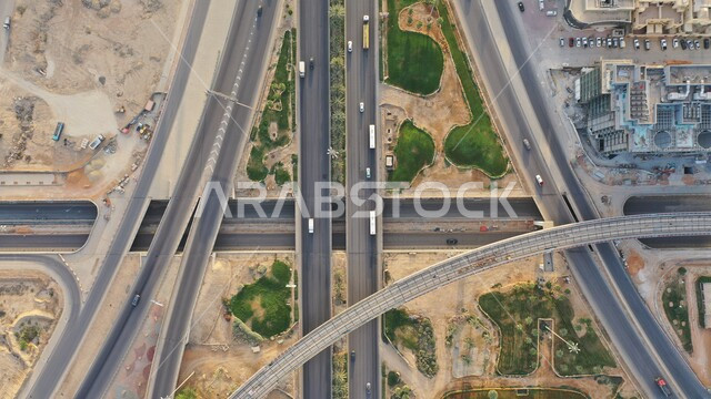 Urban development and growth of facilities and residential and commercial buildings in Saudi Arabia, an air image of the traffic movement in the roads and streets of the Kingdom, architectural art in the modern style of famous skyscrapers in Riyadh