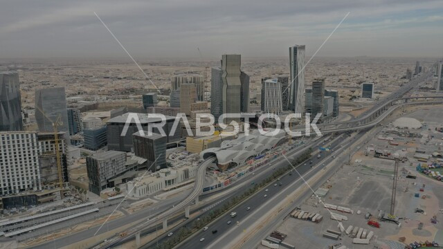 Skyscrapers, financial and economic towers, and architectural facilities, an aerial shot of the King Abdullah Financial Center (CAFD) in the capital by day, traffic in the streets of Riyadh, urban growth and progress in the modern style, famous tourist attractions