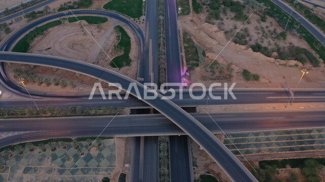 الاهتمام بزراعة الأشجار و النباتات في المدن، صورة جوية للحركة المرورية في طرق وشوارع المملكة، النمو والتطور العمراني للمنشآت والمباني السكنية والتجارية في السعودية، الفن الهندسي المعماري على الطراز الحديث لناطحات السحاب المشهورة في مدينة الرياض