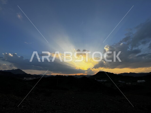 White clouds blocking the sun's rays at sunset in Al-Eis Governorate, natural scenes in the Saudi sky, natural background