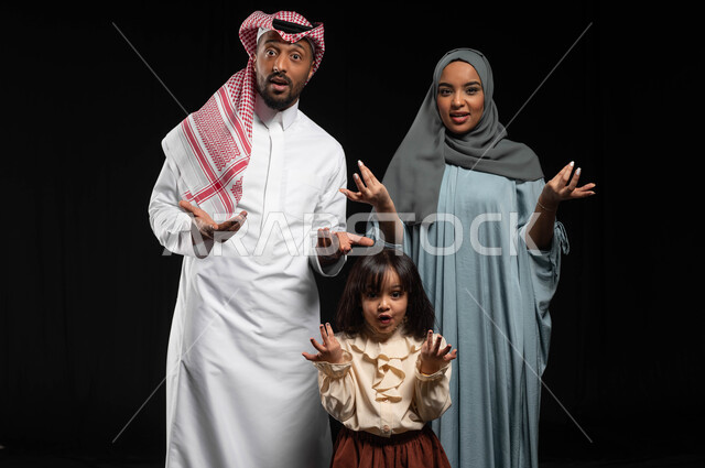 Hesitation and lack of confidence regarding a particular topic, a portrait of a Saudi Gulf Arab family raising their palms with gestures of uncertainty and astonishment, feeling confused and wondering about something, standing straight and looking at the camera, black background