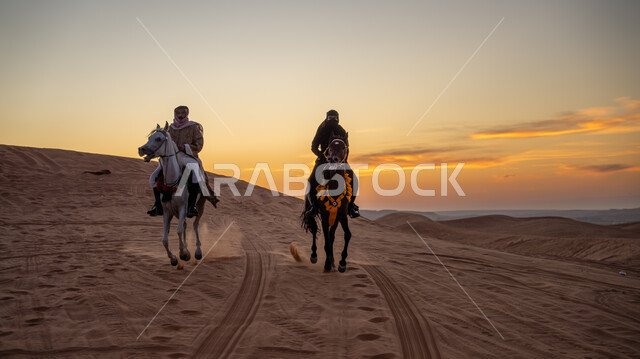 ذكرى تأسيس الدولة السعودية الأولى في 22 فبرير، التجول في الصحراء على ظهر الحصان، يوم بدينا 1727م, ارتداء الأزياء الشعبية التقليدية، الاستمتاع بممارسة الأنشطة الترفيهية في المناطق الصحراوية, فارس وفارسة عربيان خليجيان سعوديان يمتطيان الجياد العربية الأصيلة