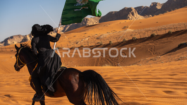  إحياء التراث السعودي التقليدي الشعبي، رفع علم المملكة في اليوم الوطني في 23 سبتمبر, يوم بدينا 1727م, ذكرى تأسيس الدولة السعودية الأوى في 22 فبراير, فارسة عربية خليجية سعودية ترتدي العباءة السوداء تمتطي فرس بني أصيل, يوم العلم 11 مارس