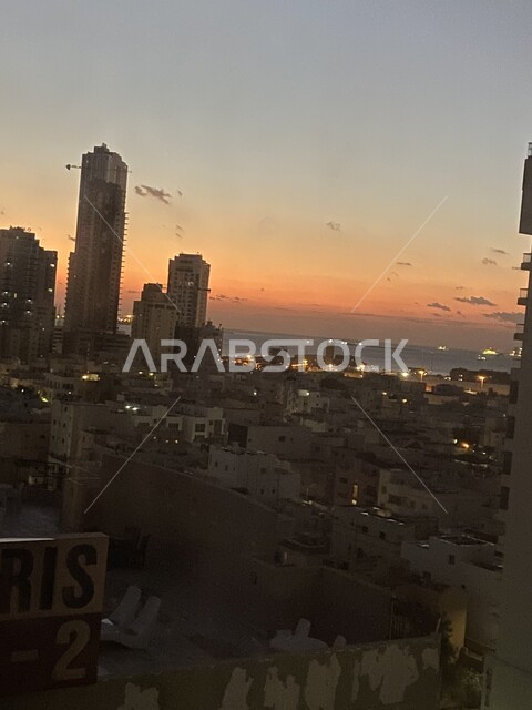 Architectural engineering art of towers, skyscrapers, and modern-style residential facilities, an aerial photo of the city of Bahrain at sunset, population crowding in tourist cities, progress and development in building architecture