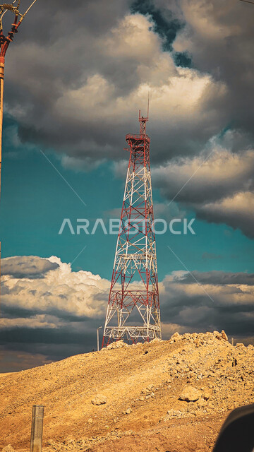 The mountain range, the formations and stone formations, the view of the clouds condensing in the sky of the city of Haql in the Kingdom of Saudi Arabia, the overcast black clouds, the wide rocky areas
