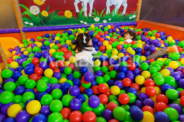 طفلان سعوديان في مدينة الألعاب ، يلعبان في حوض الكور البلاستيكية ، قضاء اوقات رائعة في مدينة الملاهي ، العاب الكترونية ، التسلية و الترفيه ، الترفيه في العطلة الصيفية