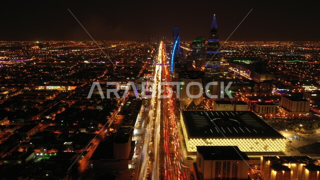 Development and interest in the country's infrastructure, towers and skyscrapers illuminated at night, famous tourist attractions, peaceful night scenes in the Kingdom of Saudi Arabia, public road and car traffic, architectural engineering of buildings and facilities in the city of Riyadh