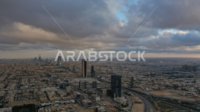 Working to develop modern engineering buildings, cloudy skies, advanced architectural arts and designs for the streets of Riyadh, towers and skyscrapers in Saudi Arabia, economic and commercial renaissance, famous places and landmarks.