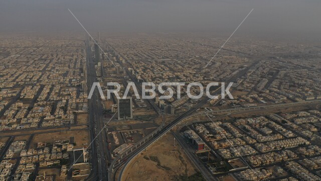 Urban development and growth of residential and commercial facilities and buildings in Saudi Arabia, an aerial photo of traffic movement on the roads and streets of the Kingdom, modern architectural engineering art, car traffic on the public road, the skyline of the city of Riyadh