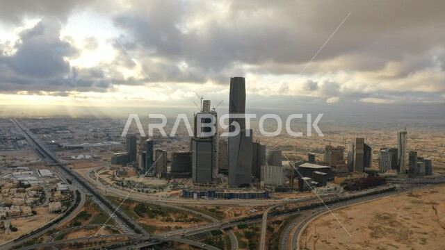 Urban growth to stimulate tourism in the Kingdom, architectural engineering art for buildings, skyscrapers and towers in Saudi Arabia, King Abdullah Financial Tower in the city center, famous heritage tourist places and landmarks in Riyadh, development and progress of roads and streets, cloudy sky